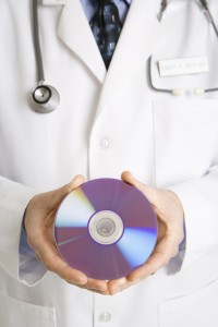 Doctor holding compact disc Physicians need to encrypt hard media for maximum security.